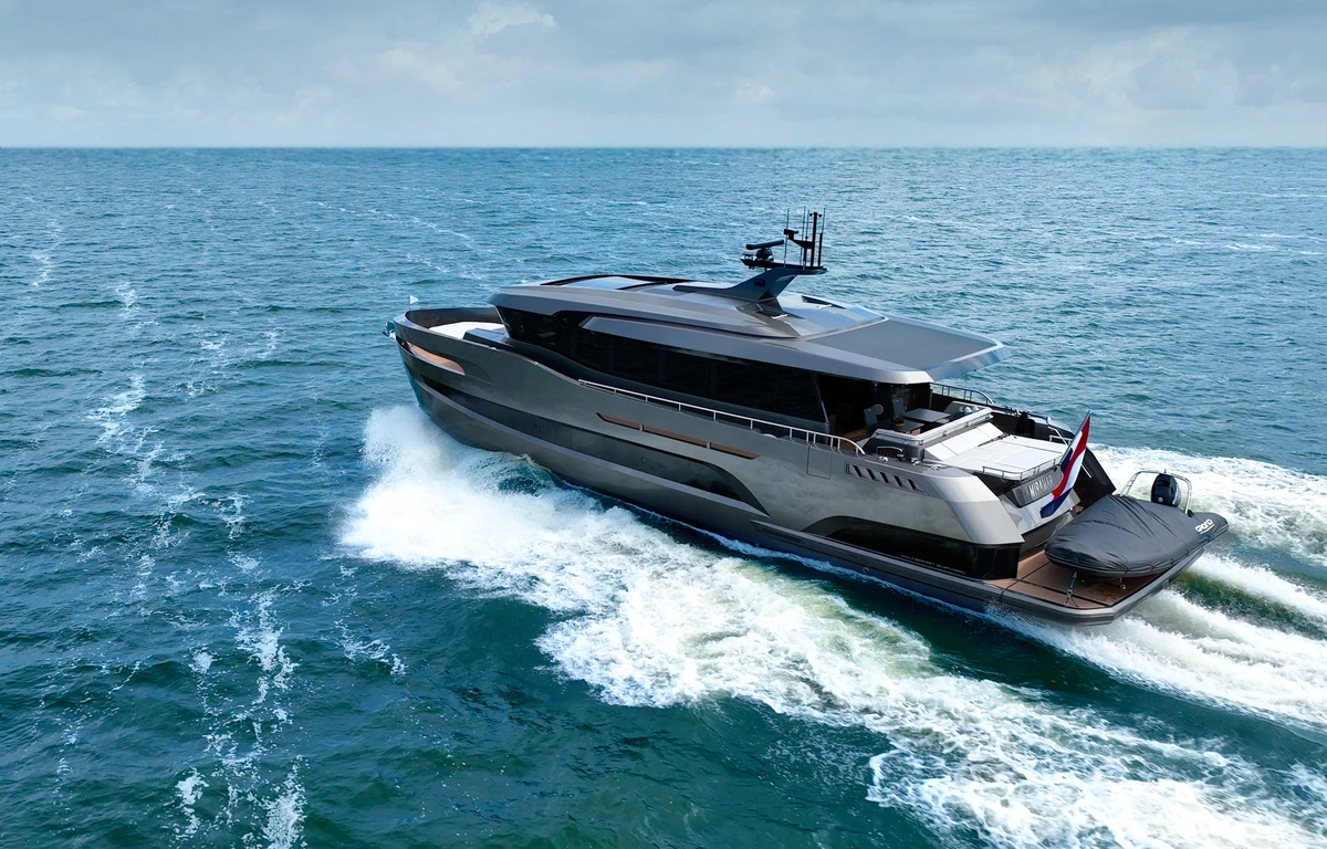Holterman 78 Sport - in a grey colour, moving through deep blue water and a cloudy sky.